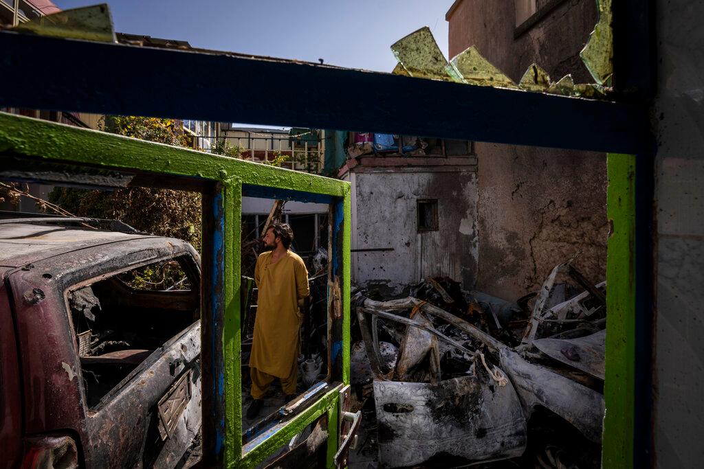 A man inspects the damage to a home, where an errant US drone strike killed 10 people including seven children. Photo: AP