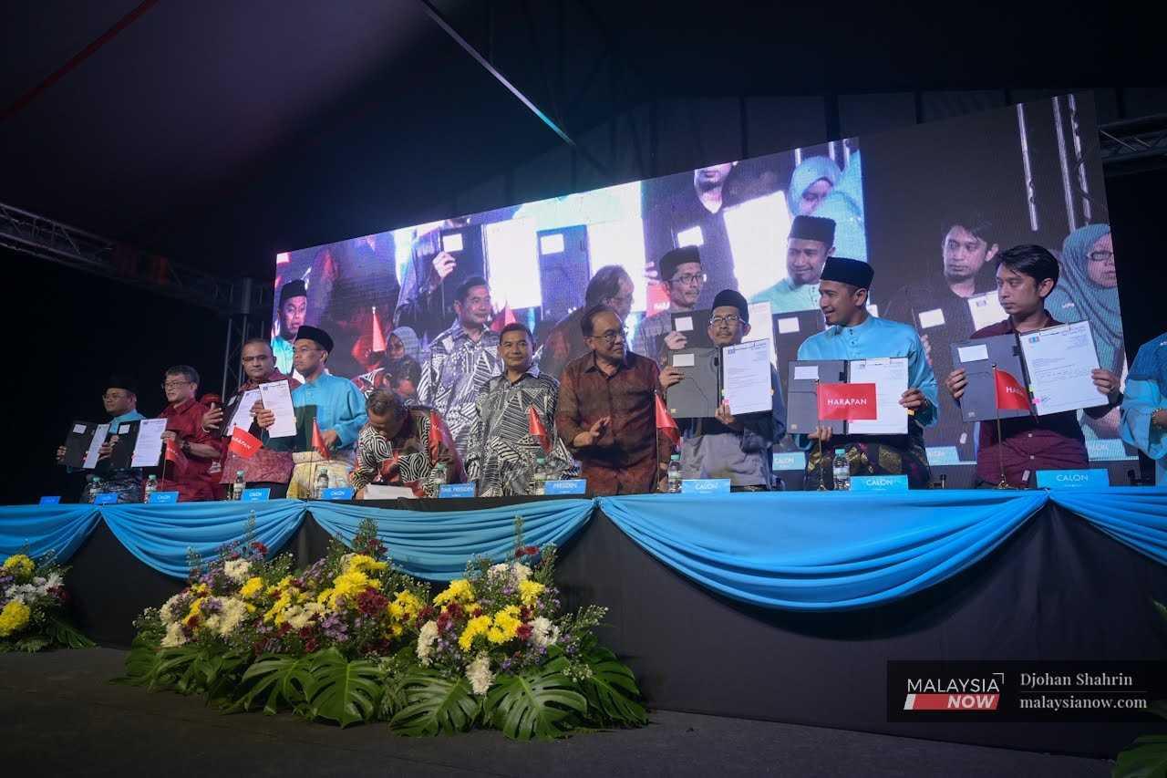 PKR president Anwar Ibrahim speaks to the party's candidates for the 15th general election during their announcement at Padang MPAJ in Taman Kosas Ampang, Selangor. 
