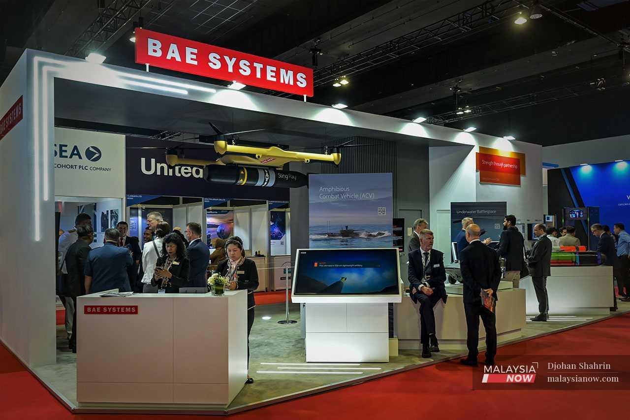Personnel wait to welcome visitors to the BAE Systems booth. The aerospace, defence and security information firm is based in London.