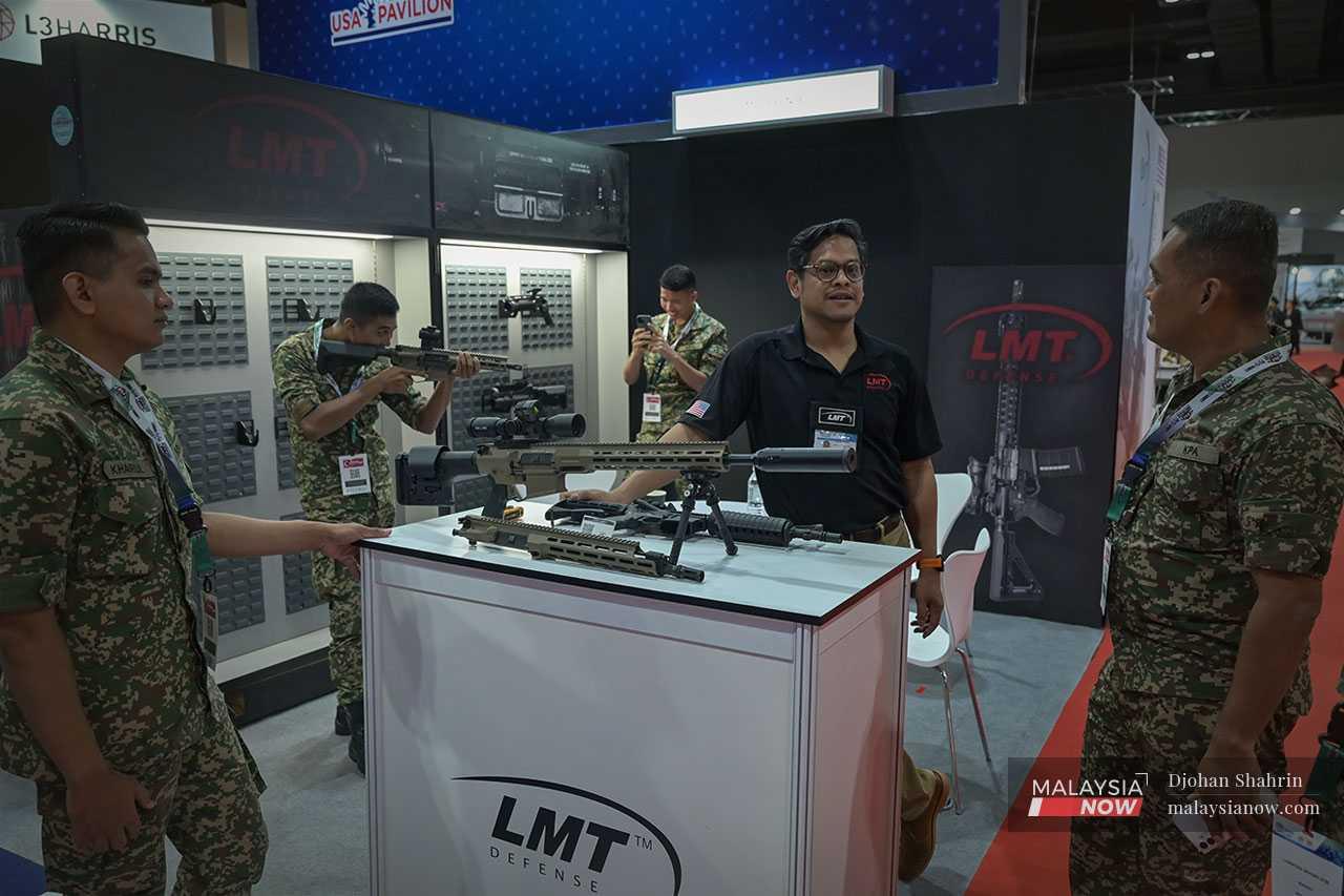 Defence personnel ask questions about the US-made LMT Defense equipment.