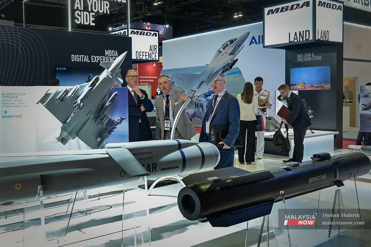 A spokesman from European missile developer and manufacturer MBDA briefs visitors on the company's products.