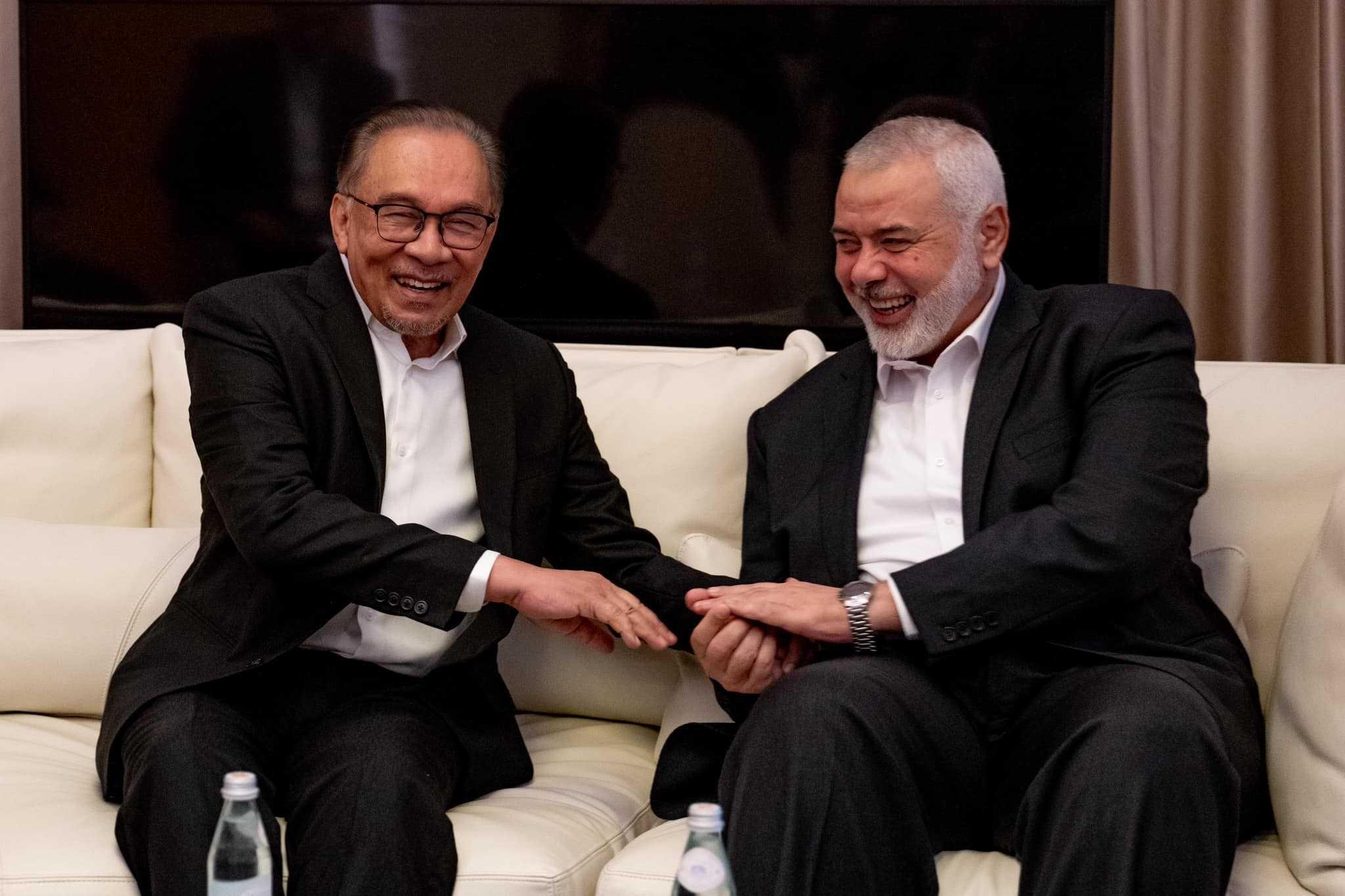 Prime Minister Anwar Ibrahim, seen here with Hamas political bureau chief Ismail Haniyeh during a meeting in Qatar last month, says he has discussed with the group about Malaysia doing business with companies linked to Israel.