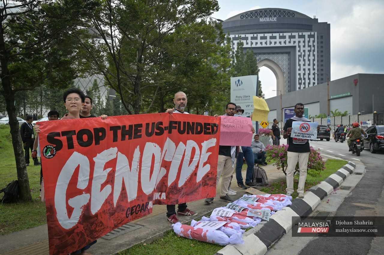 A group protesting the Malaysian government's move to allow US arms contractors facing accusations of war crimes to take part in a defence exhibition in Kuala Lumpur last month.