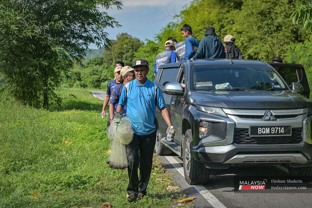 Armed with nets, volunteers have made it their job to hunt down and catch these foreign fish.