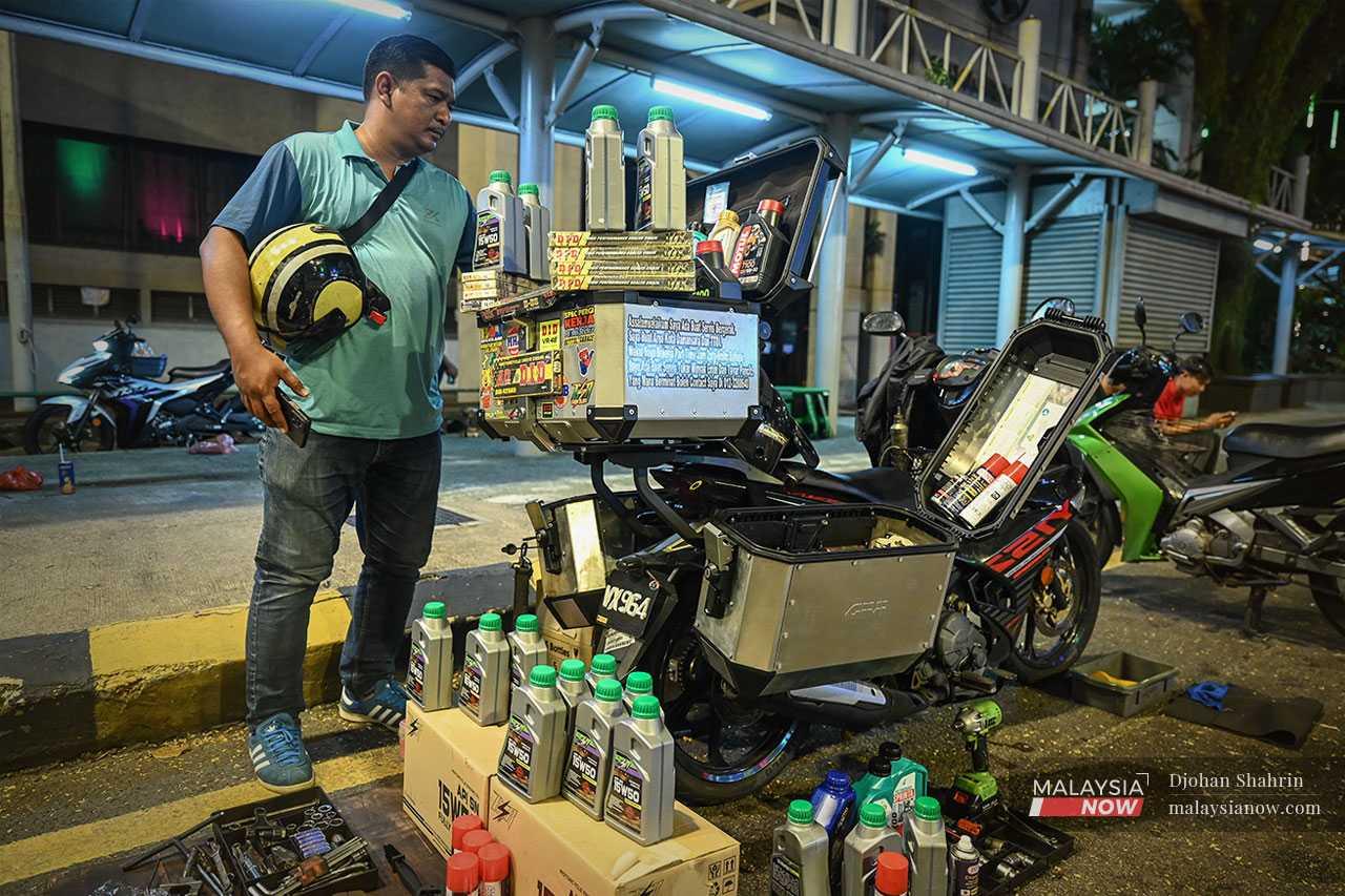 Yusof's motorbike is a workshop on the move and he brings a variety of spare parts with him wherever he goes.