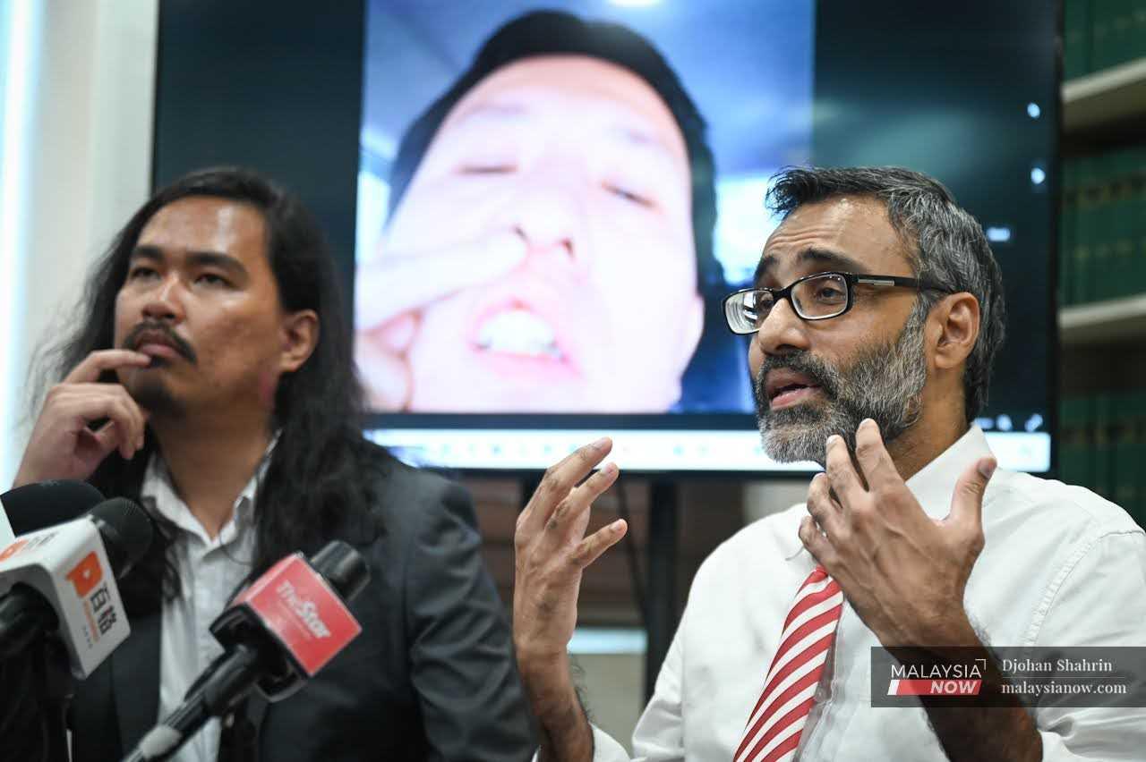 Lawyers for Liberty's Zaid Malek and N Surendran at a press conference to reveal a dashcam recording of the May 28 assault on Grab driver Ong Ing Keong.