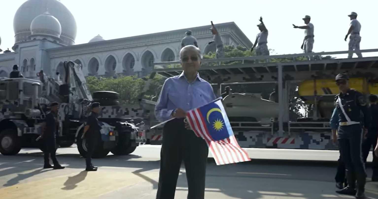 Dr Mahathir Mohamad waves the Jalur Gemilang as he attends the Merdeka Day celebration in Putrajaya on Aug 31.