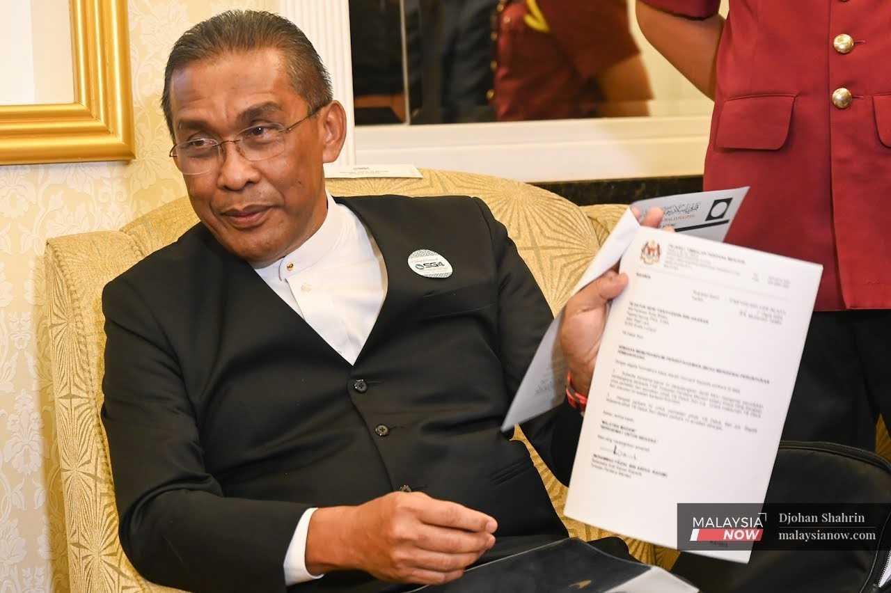 Perikatan Nasional chief whip Takiyuddin Hassan shows a copy of the draft MoU, which he says contains several 'unusual' conditions.