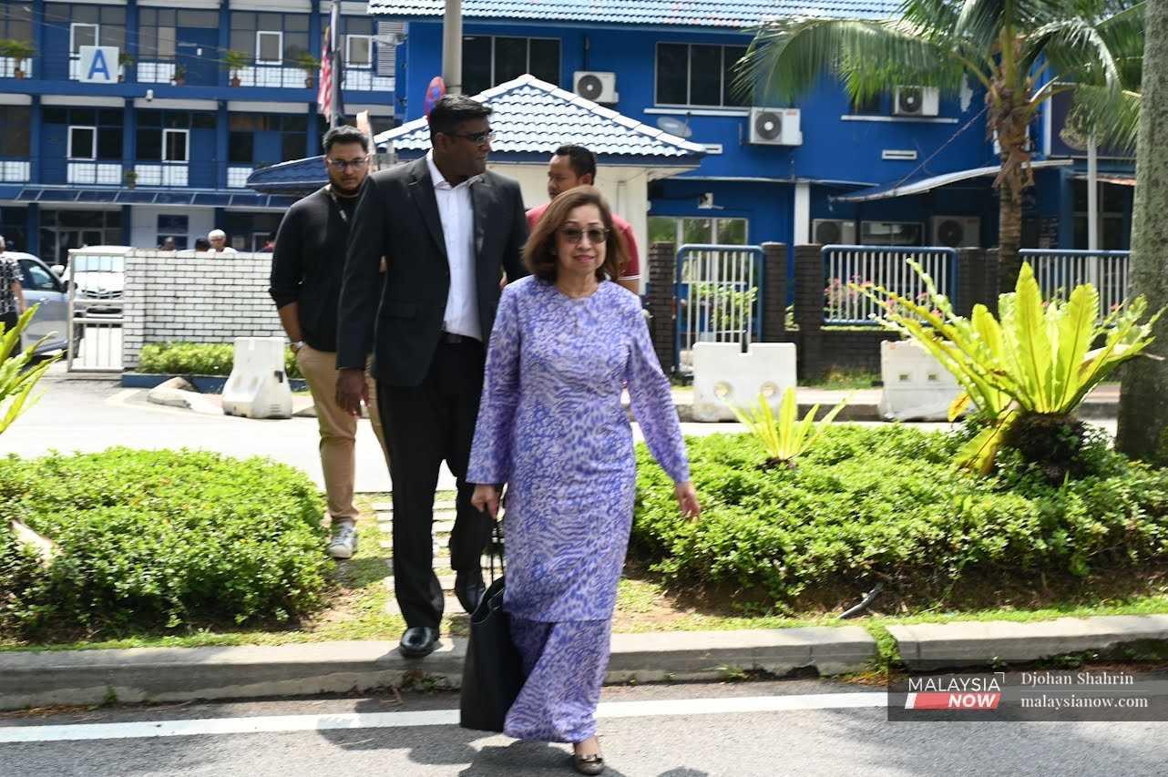 Naimah Khalid with lawyers at the Petaling Jaya police headquarters after lodging a report on behalf of her husband Daim Zainuddin.