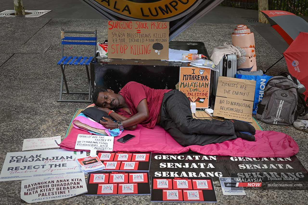 Mythreyar lies on the ground on the sixth day of his hunger strike.